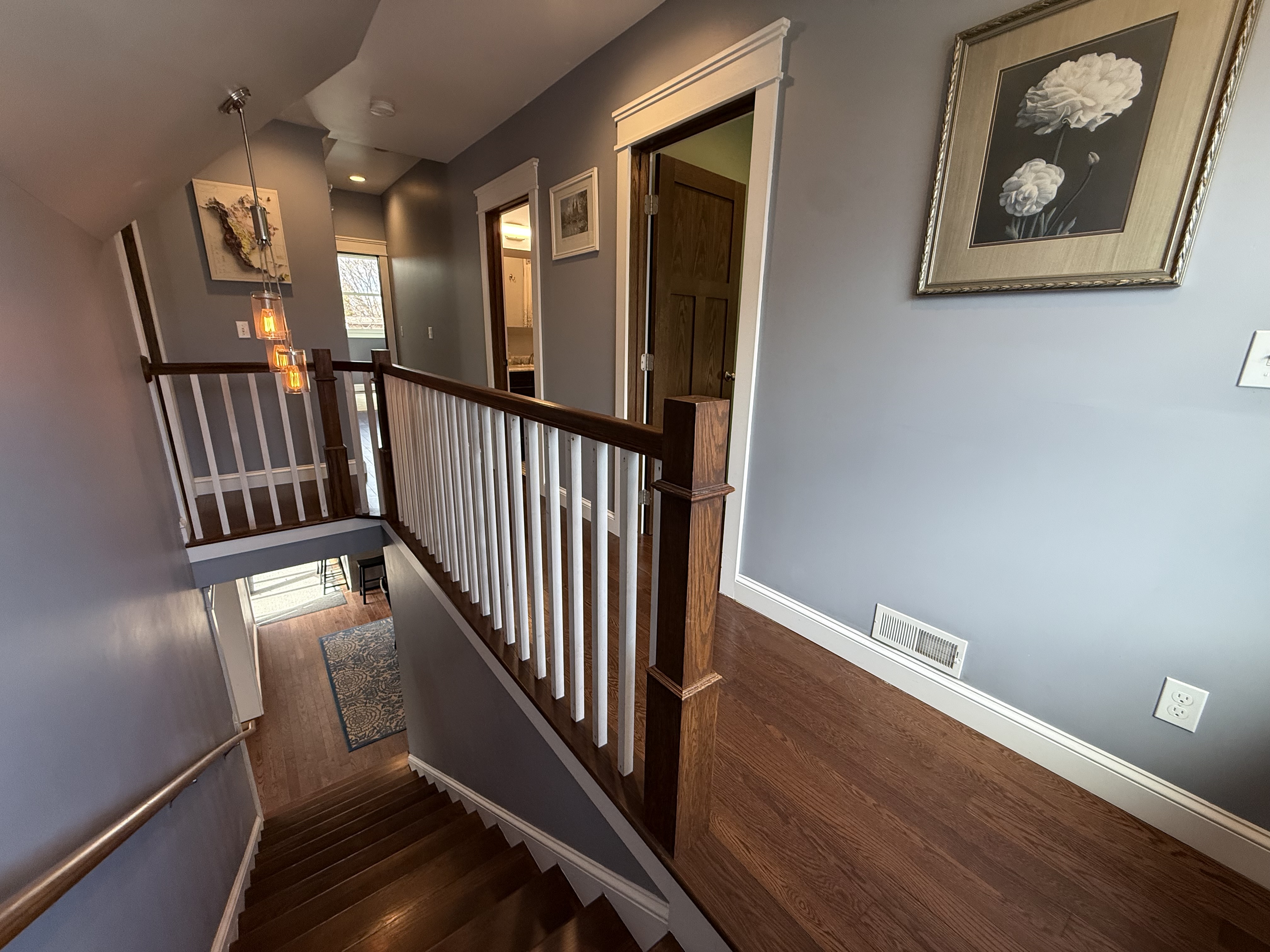 Upper hallway with staircase and pendant light