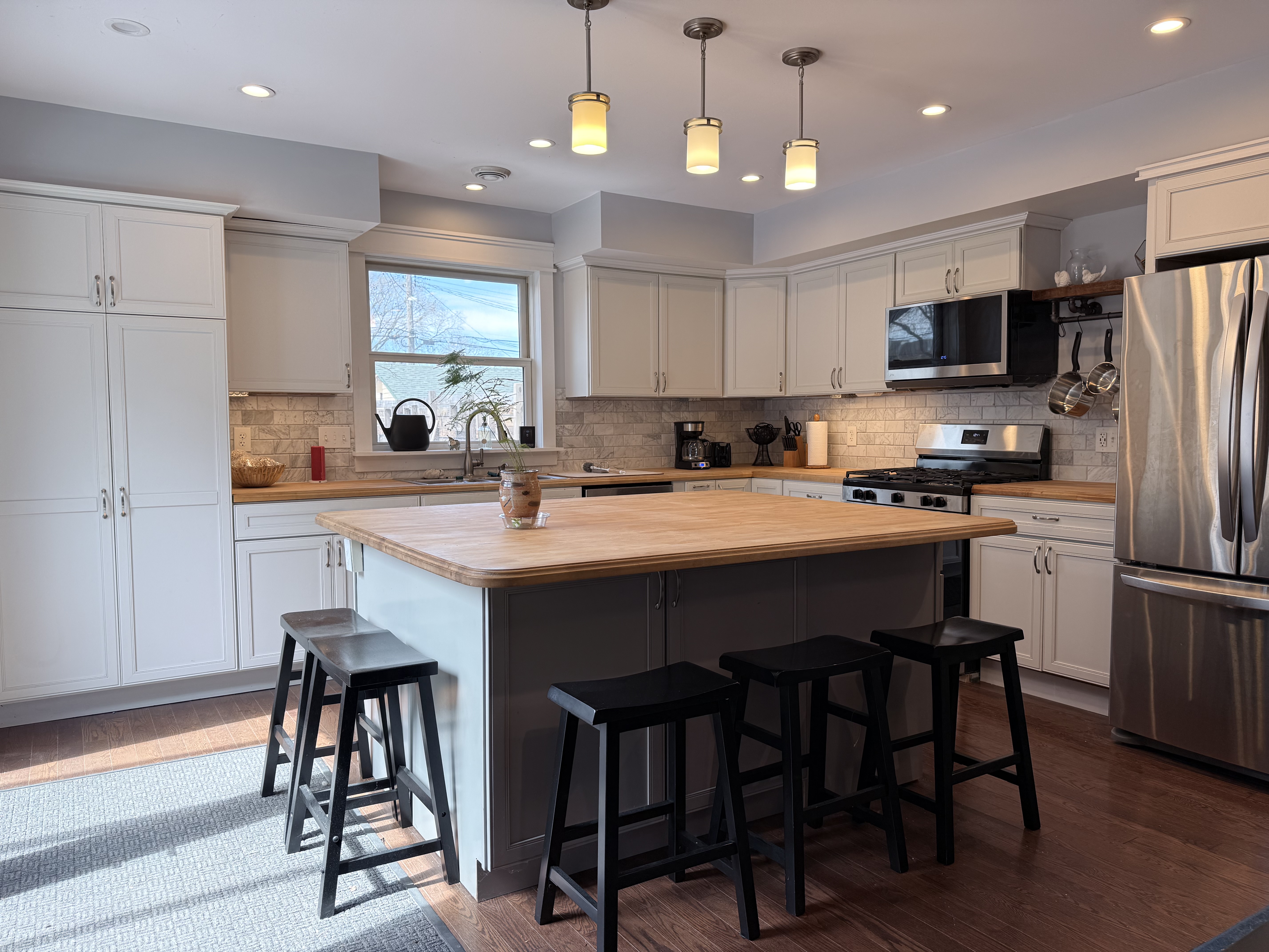 Full kitchen view with island and appliances