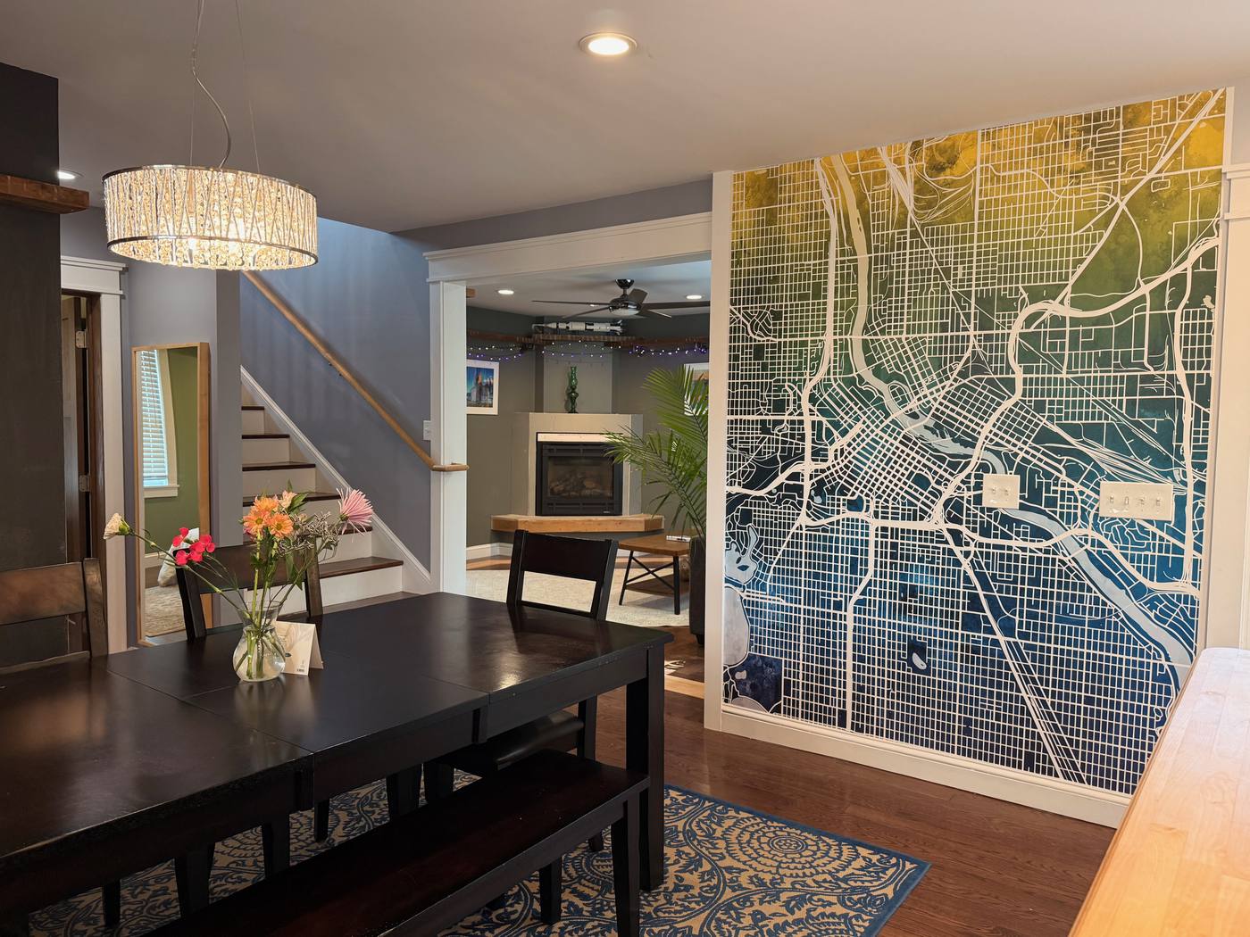 Dining area with Minneapolis map mural and open plan living